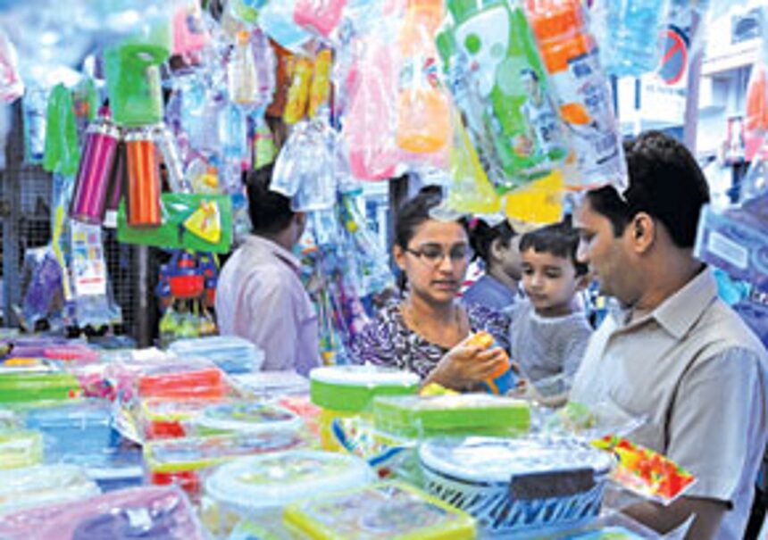 Parents shop for water bottles, raincoats and other items for their children