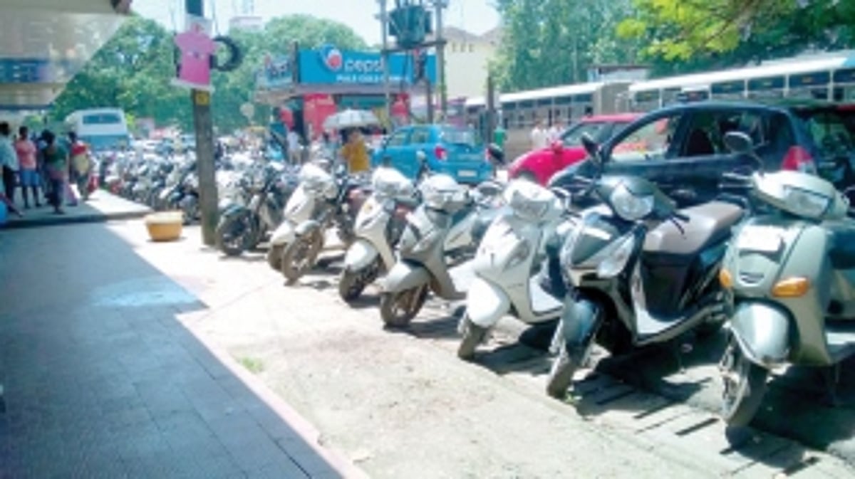 Parked two-wheelers leave little space for pedestrians