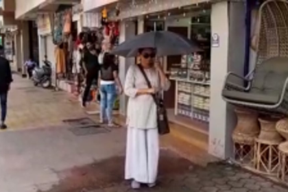 Pedestrians have to bear with water falling on them from air conditioners in the city