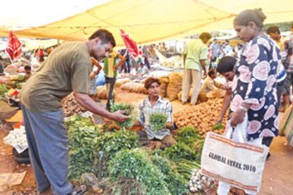 People make purchases at the weekly bazaar in Chaudi-Canacona