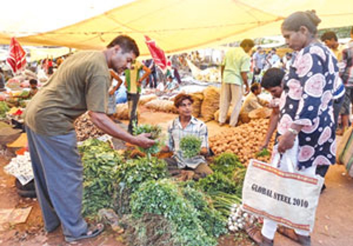 People make purchases at the weekly bazaar in Chaudi-Canacona