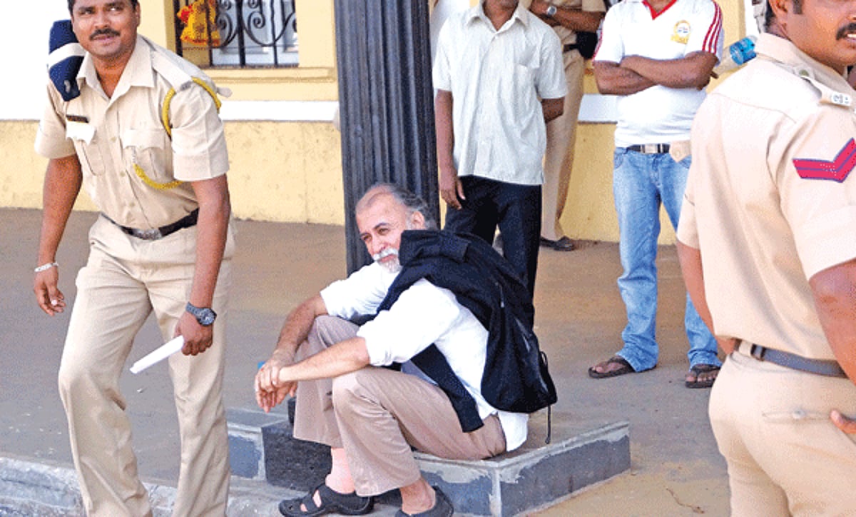 Police escort former editor of Tehelka, Tarun Tejpal as he sits and awaits for vehicle infront of the Old Secretariat in Panjim on Thursday.