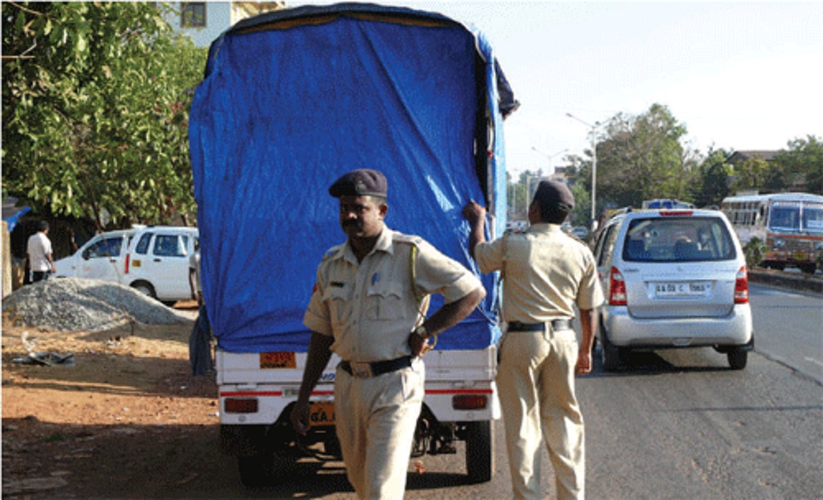 Police personnel checking vehicles under the direction of elections officials near Chodankar Hospital, Porvorim to check violations of election code of conduct.