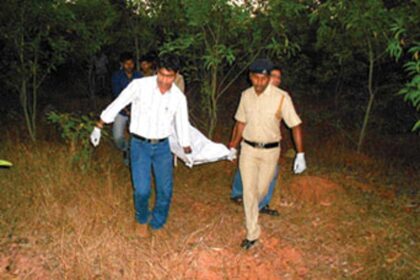 Police recover the body from the crime site.