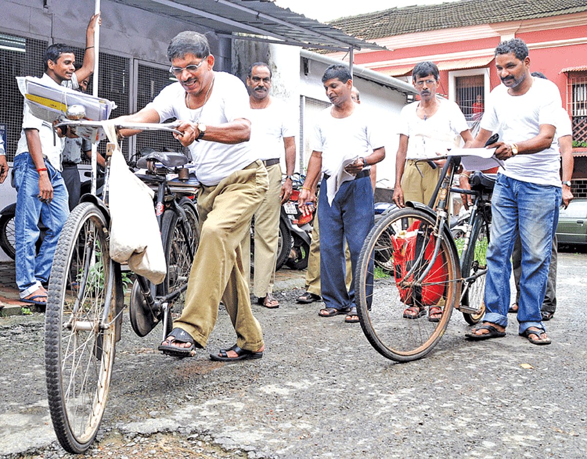 Postmen from Department of Posts, leave to deliver mail in vests to protest against substandard and irregular supply of uniforms and other kit in Panjim on Tuesday.