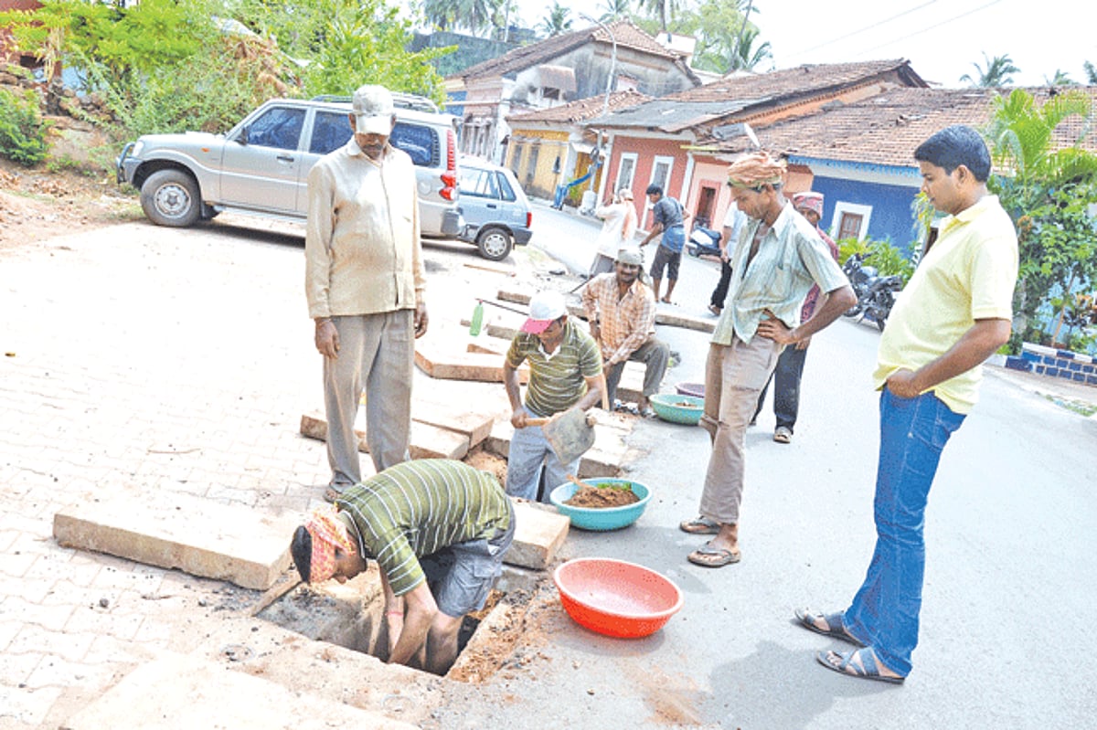 Pre-monsoon preparation: Labourers, being supervised by a CCP corporator, clean the drainage at Mala- Fontainhas, Panjim ahead of rains, on Sunday.