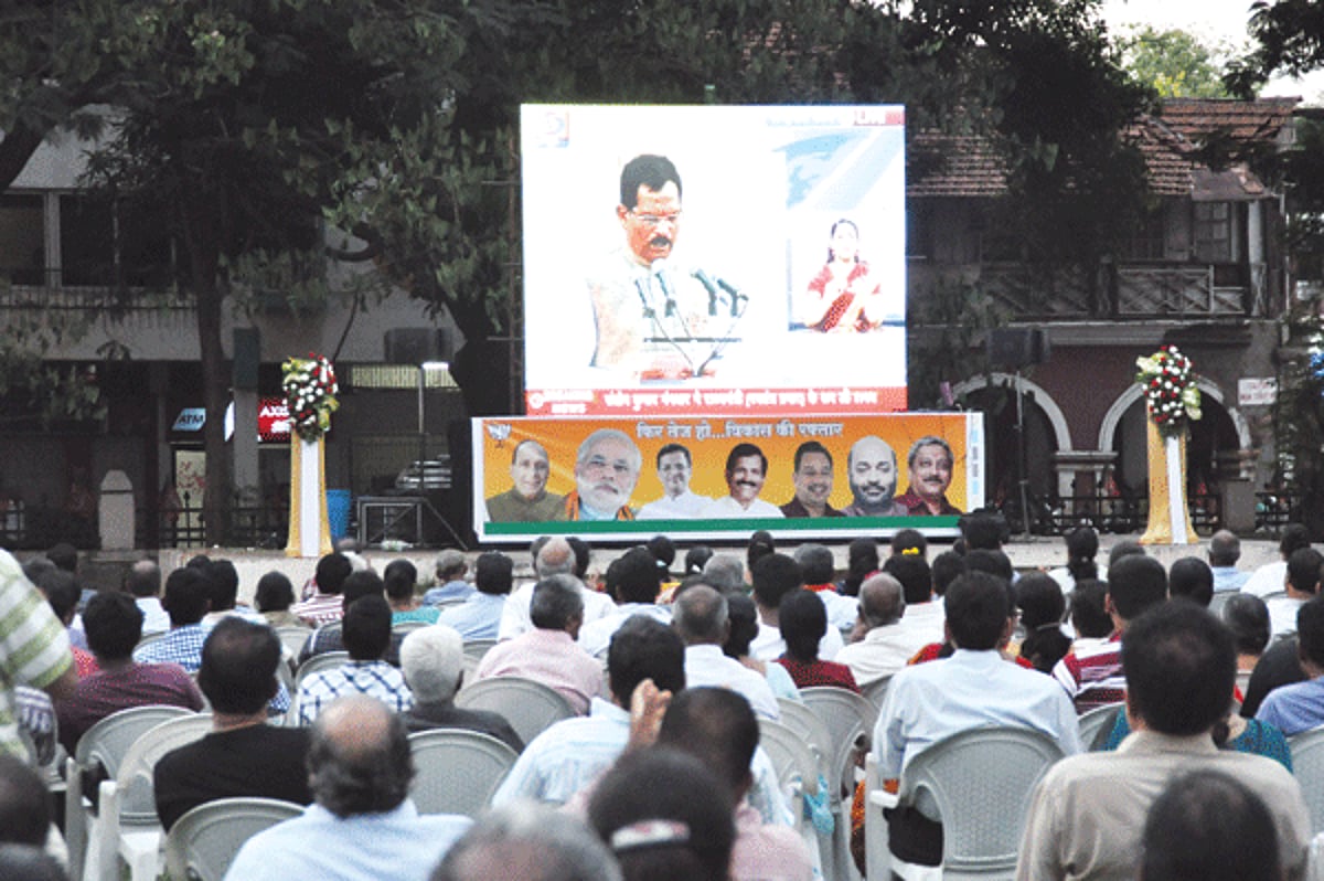 Public and supporters of BJP watch the swearing-in ceremony of Shripad Naik as minister of state with independent charge on a giant screen at Azad Maidan, Panjim, on Monday. Photos: