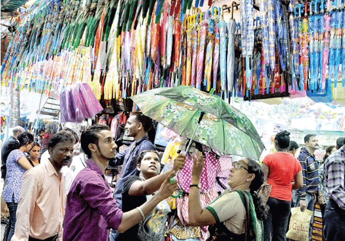 RAINDROPS?KEEP?FALLING?ON?MY?HEAD?: Customers select umbrella amongst a colourful lot displayed at a shop in the Panjim market. With monsoons just round the corner, vendors dealing in rainwear make brisk business.