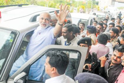 REACHING OUT: Narendra Modi waves out to the crowd on his arrival at Dabolim airport