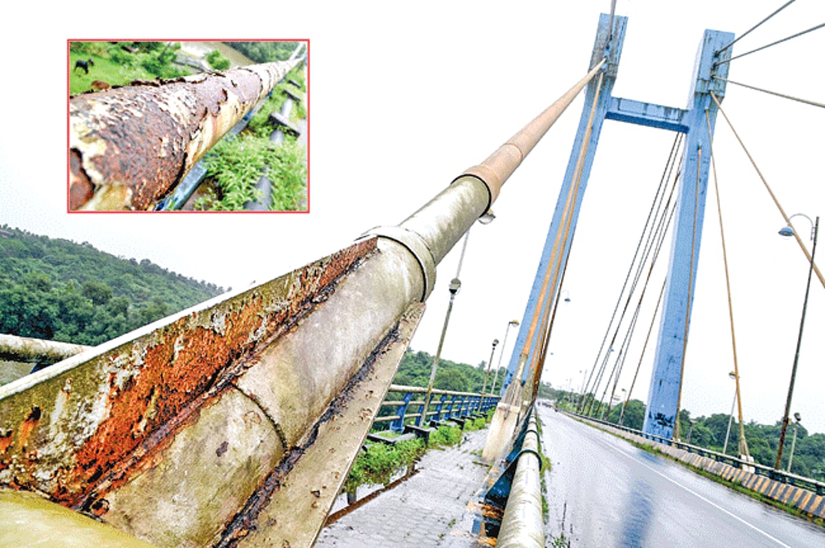 RUSTING IN PIECES: This cable stayed bridge connecting Aldona and Corjuem villages needs a fresh coat of paint after nearly seven years of exposure to elements since its inauguration in 2004. (Inset) The peeled paint exposing the rust on the side railings
