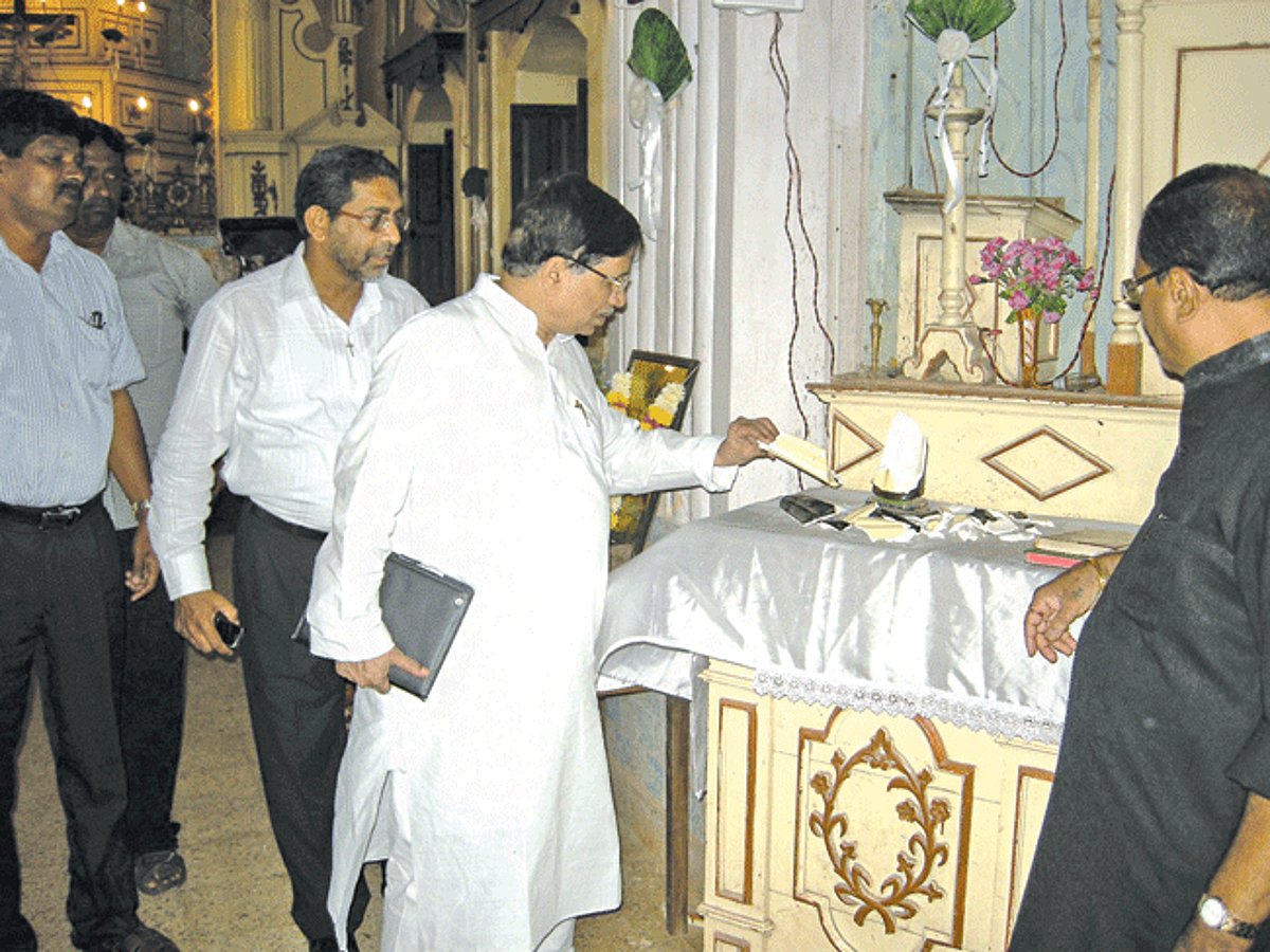 Rajya Sabha MP Shantaram Naik with Assolna Parish Priest Fr Lucio Dias inside the desecrated St Joseph Chapel, Banda.