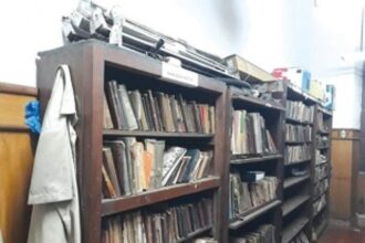 Rare sight: Plastic buckets, uniforms adorn shelves of rare book section in MMC library