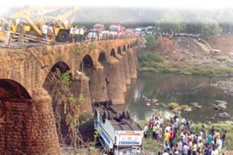 Rescue officials and bystanders gather around the wreckage of the bus