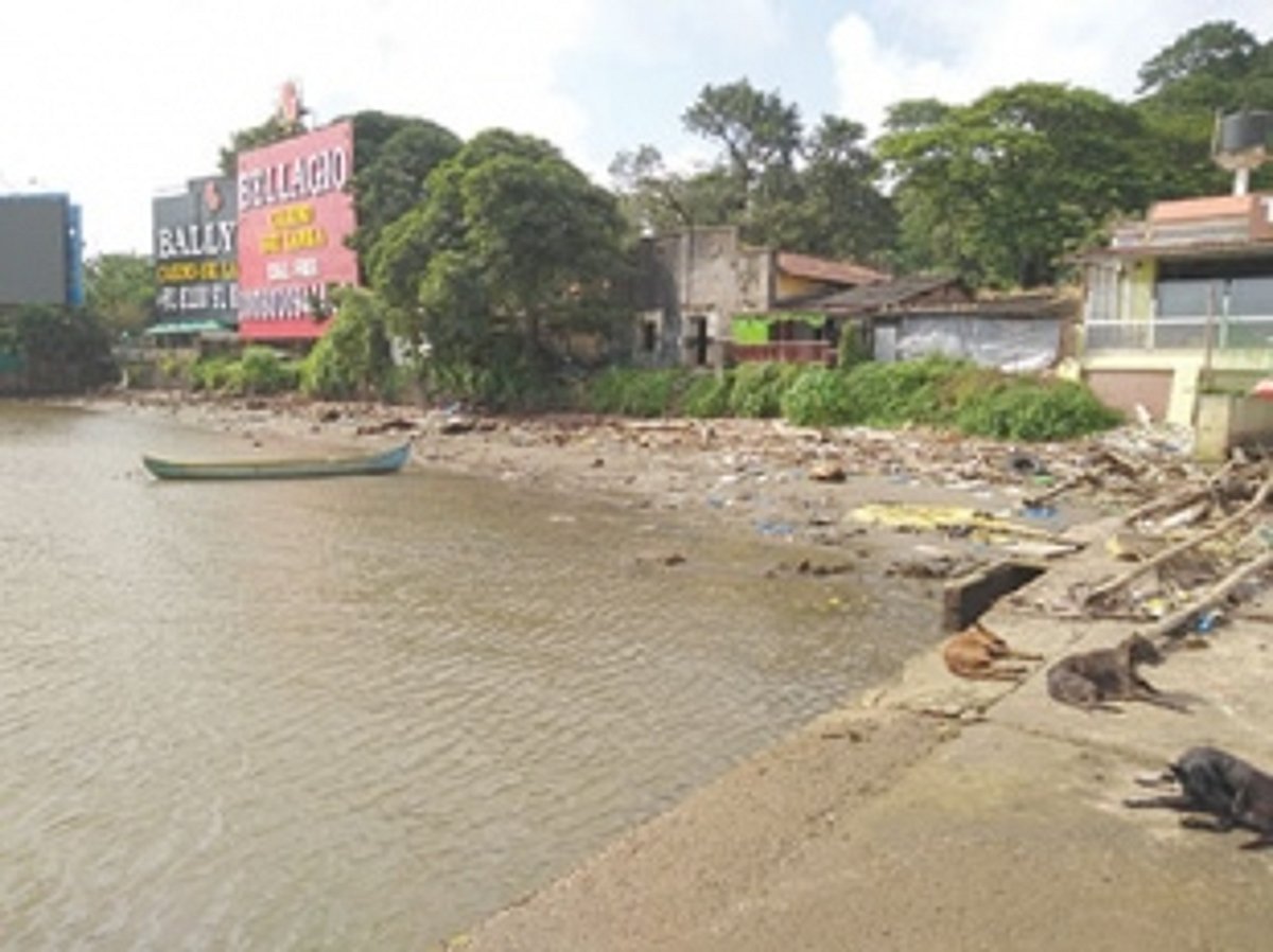 Rubbish piles along ferry  wharfs in Mandovi River