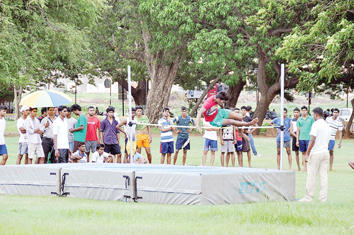 SETTING THE BAR HIGHER: A candidate tries his luck on the high jump as other look on at the physical fitness test held for the posts of police constable in Goa Police at SAG ground, Campal, on Monday
