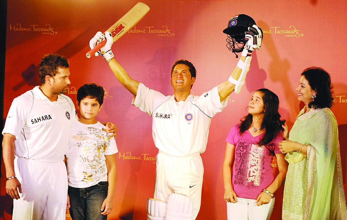 Sachin Tendulkar, along with his son Arjun, daughter Sara and wife Anjali, poses with his waxwork figure at the unveiling ceremony in Mumbai on Monday.