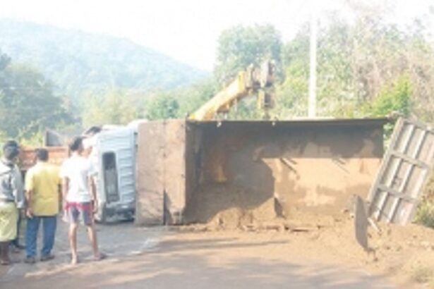 Sand-laden truck overturns  at Apewal