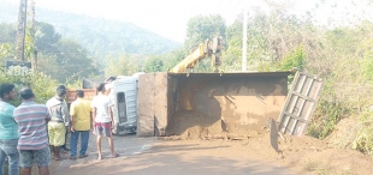 Sand-laden truck overturns  at Apewal