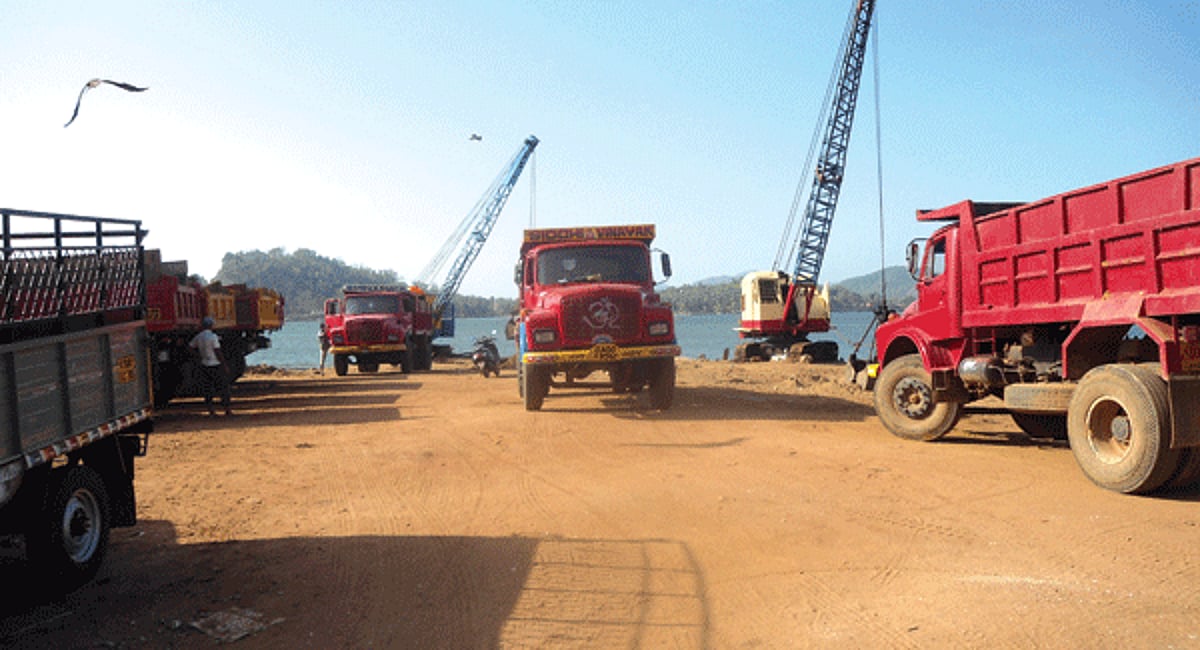Sand-loading activity with heavy machinery in progress at the Kodibag-Karwar jetty