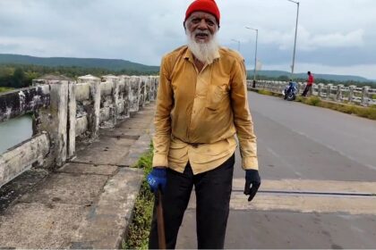 Senior Citizen cleans gutter on Kiranpani Aronda Bridge for water drainage