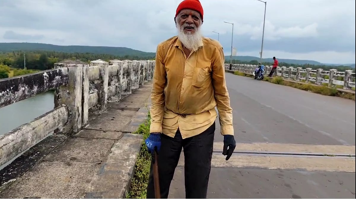 Senior Citizen cleans gutter on Kiranpani Aronda Bridge for water drainage