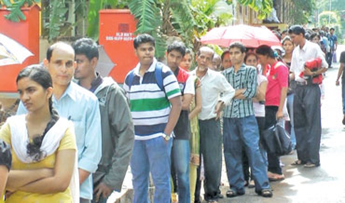 Students and parents wait in a queue outside the Education Department, Margao.