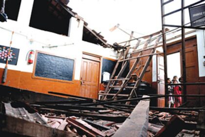 Students of the Government Primary School at Camrabhat, Tonca, look at the classroom whose roof collapsed