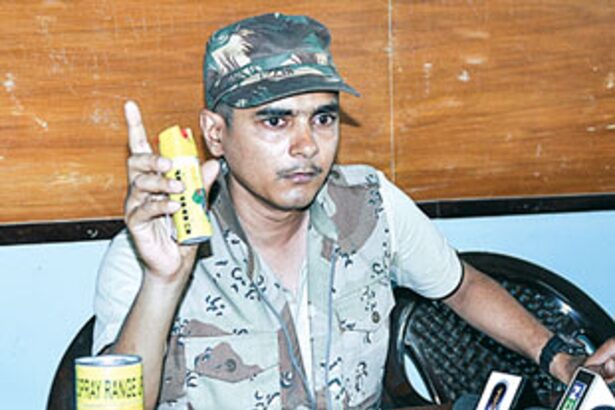 Sudip Dalvi shows a pepper spray canister at a press conference