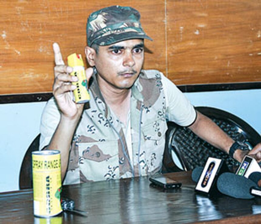 Sudip Dalvi shows a pepper spray canister at a press conference
