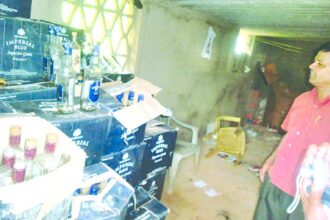 Superintendent of Excise Navnath Naik shows one consignment of illegal liquor.