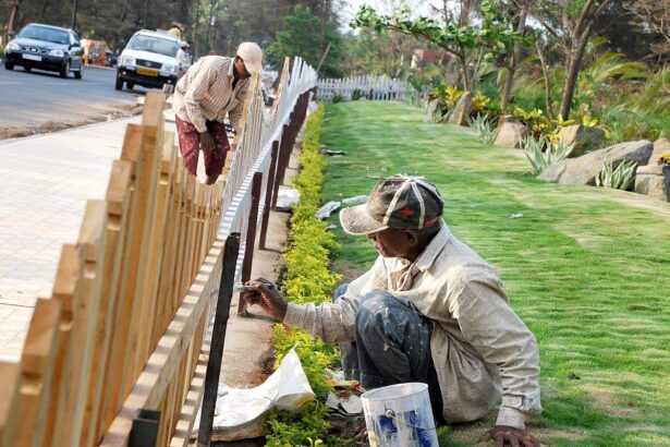THE BRUSH-RUSH! A painter gives finishing touches to a wooden railing of the promenade along the Campal-Miramar road.     Photo by Rozario Estibeiro