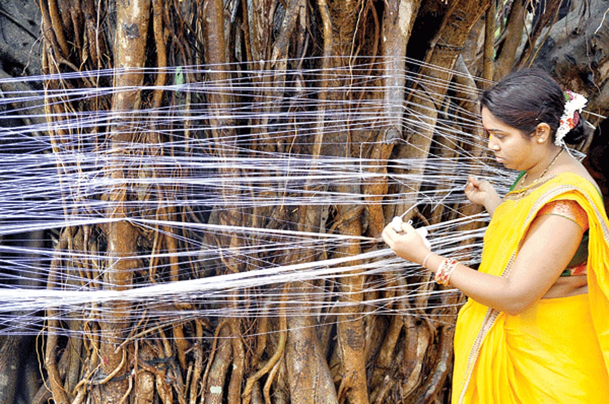 THREAD OF FAITH: A Hindu married woman ties a thread around a banyan tree on the occassion of Vat Purnimaat when wives pray for the health and longevity of their husbands, at Porvorim  on Thursday.