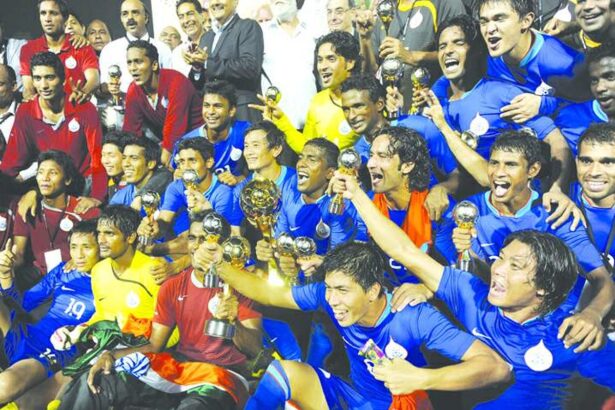 The Indian national football team players display their throphies in New Delhi on Monday.