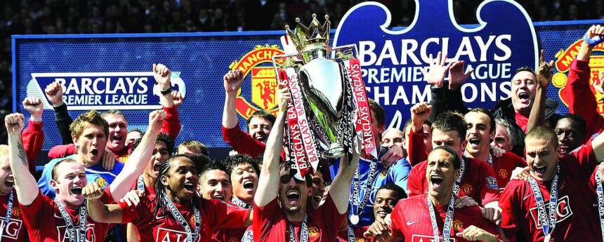 The Manchester United team celebrates with the English Premier League trophy after drawing 0-0 with Arsenal in the English Premier League football match at Old Trafford, Manchester, north-west England. 1 The Manchester United team celebrates with the English Premier League trophy after drawing 0-0 with Arsenal in the English Premier League football match at Old Trafford, Manchester, north-west England.