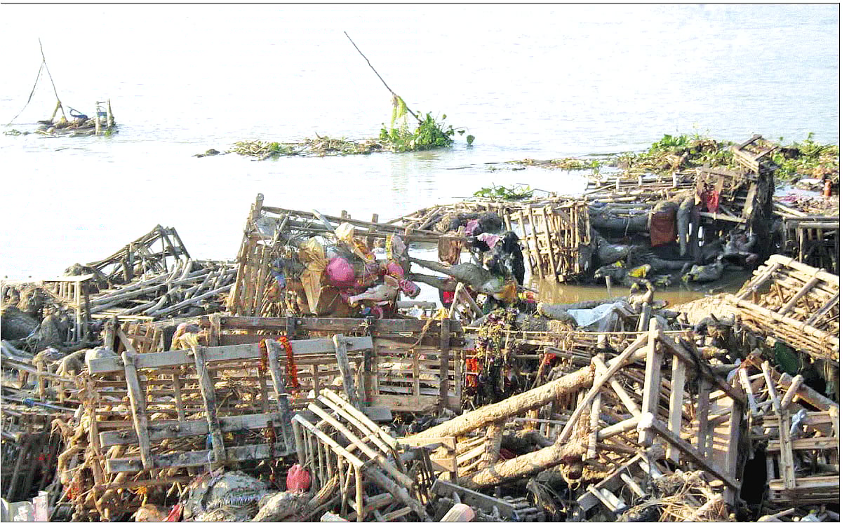 The banks of the Ganga littered with debris from Durga idols after immersion, in Kolkata on Tuesday.