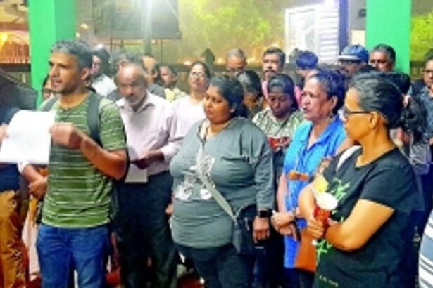 The candles of protest against music party pollution burn bright in the pouring rain