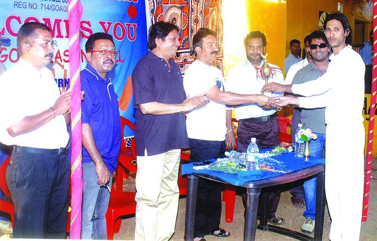 The captain of Stamina Boys, winners of 4th all-Goa season ball T20 cricket tournament organised by Manorva Sports and Cultural Club, receiving the trophy from Dayanand Narvekar at Chapora on Monday. Dayanand Mandrekar, MLA is also seen.