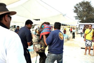 The injured Mumbai girl being lifted to a waiting vehicle after she fell from a parachute at Cavelossim beach.