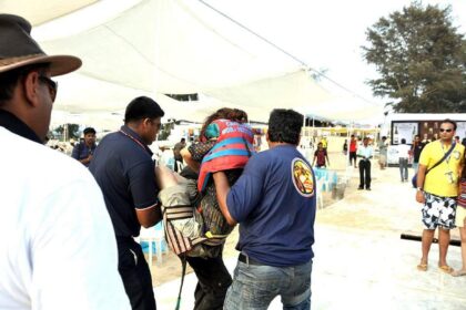The injured Mumbai girl being lifted to a waiting vehicle after she fell from a parachute at Cavelossim beach.