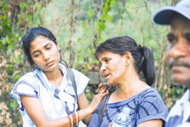 This woman at the accident site cries inconsolably over the loss of her dear one.