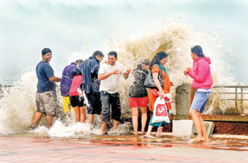 Tourists get drenched as huge waves during high tide batter the Dona Paula jetty on Monday.