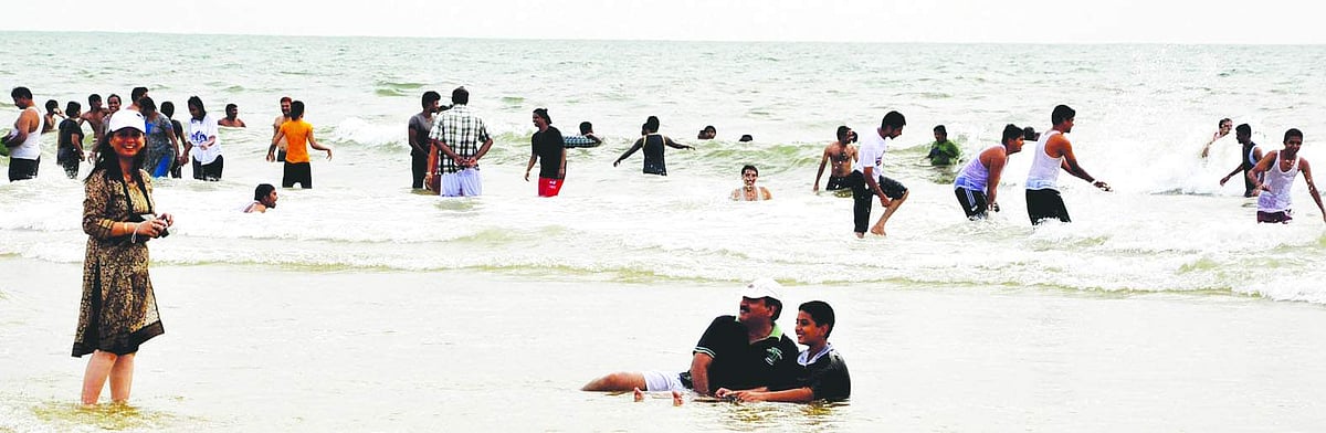 Tourists make merry at the Colva beach.