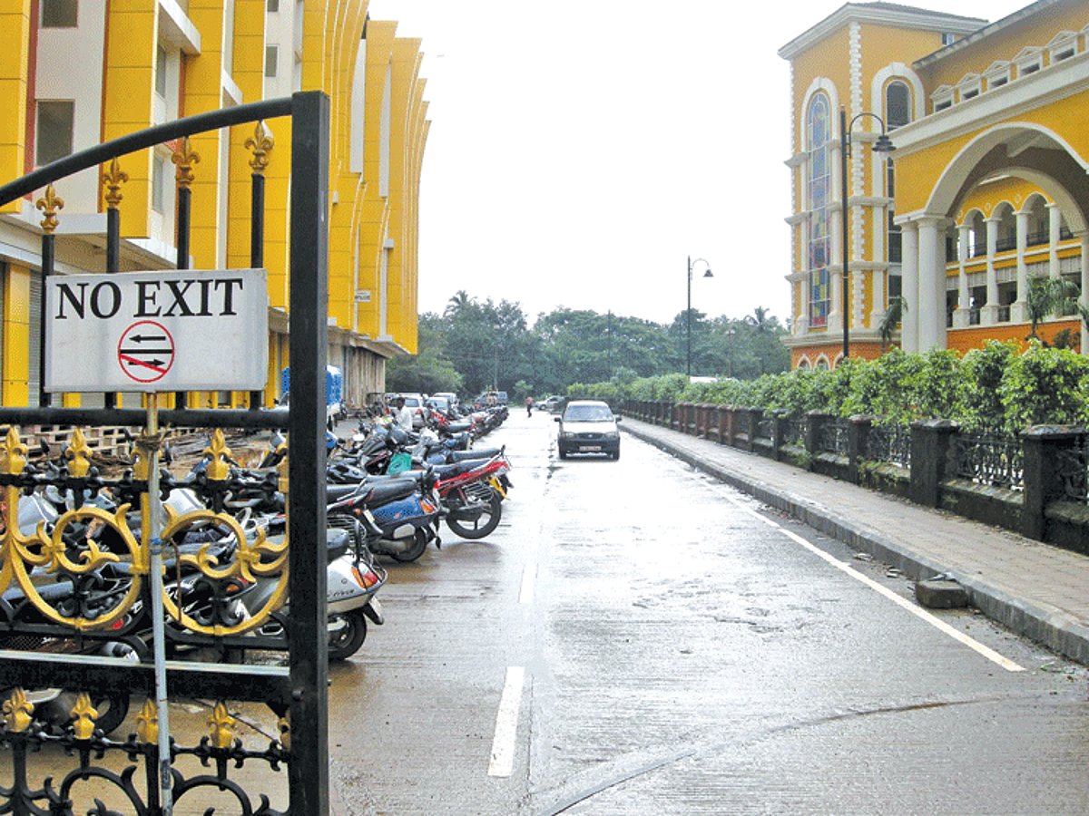 Two-wheelers parked along the road leading to the  southern side of the District Collectorate.