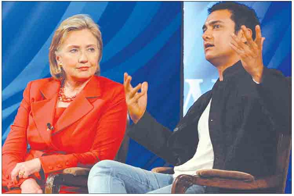 US Secretary of State Hillary Rodham Clinton reacts while listening to Bollywood actor Aamir Khan at an interactive education discussion in Mumbai on Saturday.