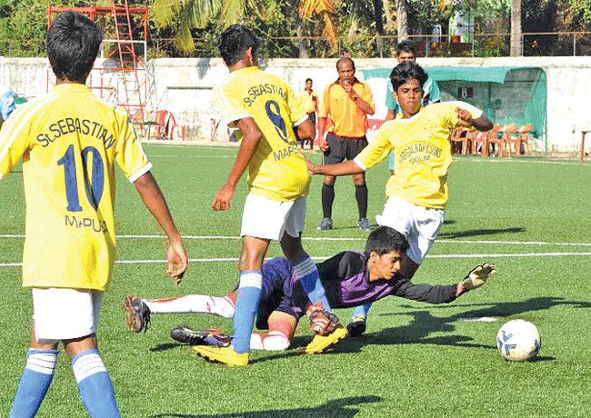 Vailankanni Sports Club goalkeeper makes an attempt to save a goal bound effort of St Sebastian Sports Club players at Duler Stadium, Mapusa, on Thursday.