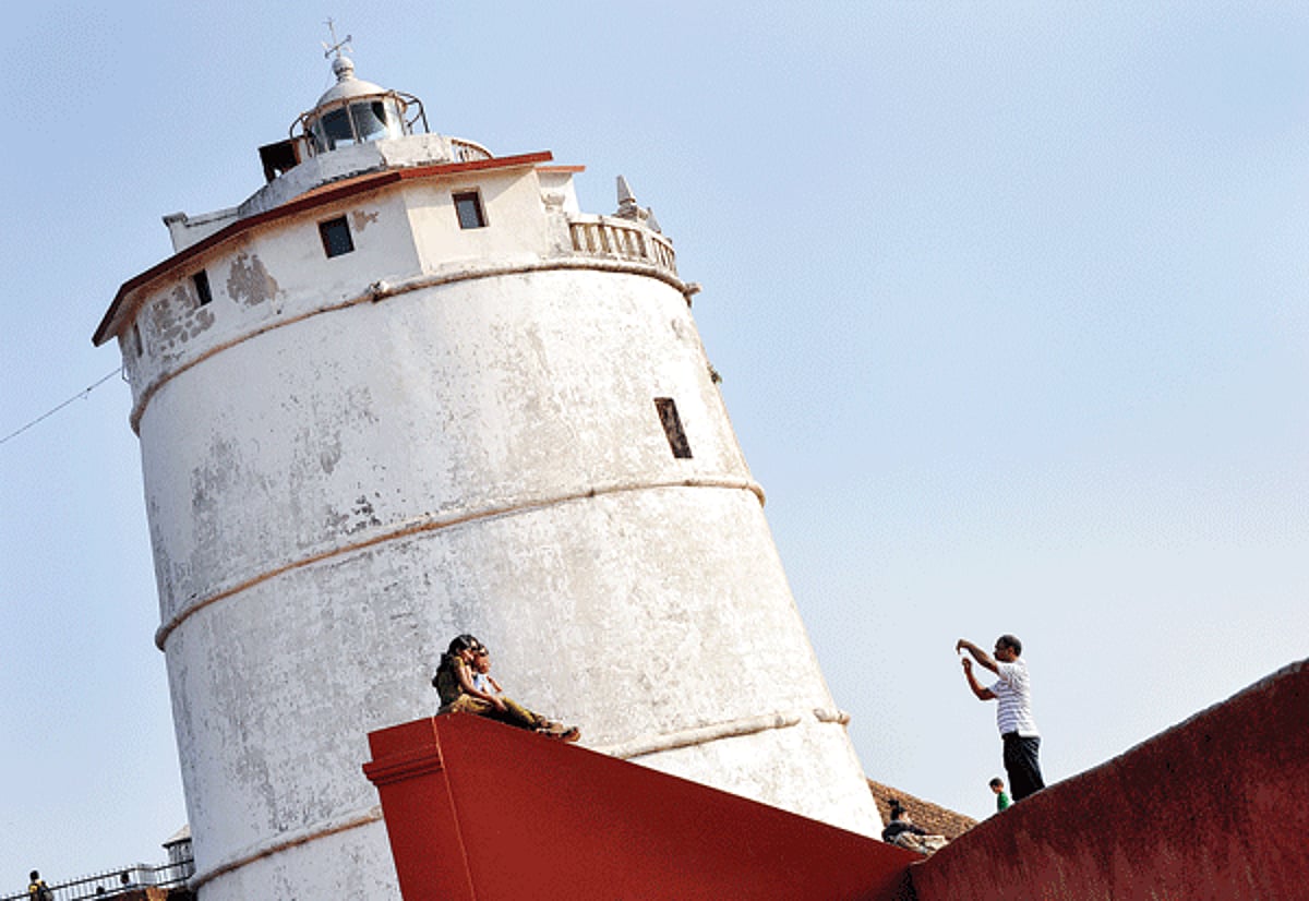 Visitors click photographs near the old lighthouse at Aguada fortress (upper) in Sinquerim. This lighthouse which used to emit light creating eclipse every 30 seconds was abandoned in 1976.