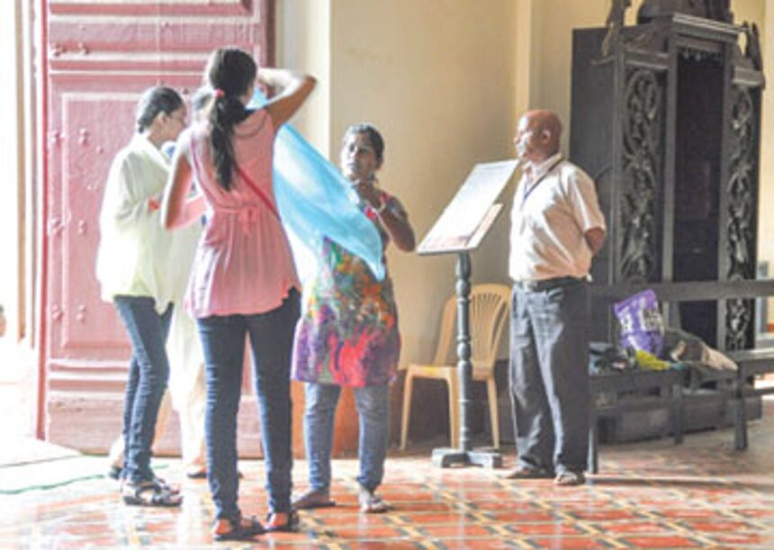 Volunteers at the Basilica of Bom Jesus loaning shawls to inappropriately dressed tourists