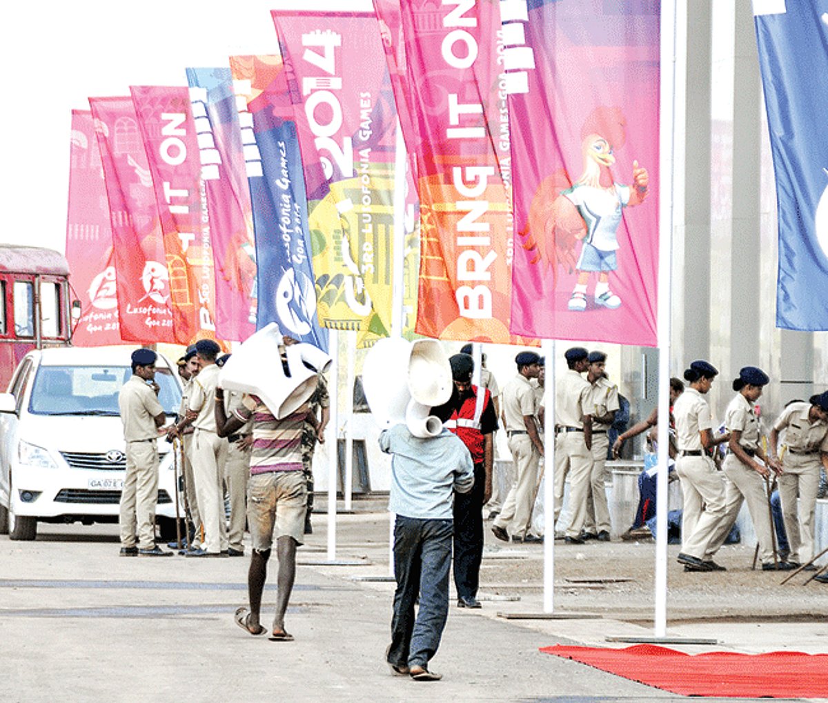 WORKERS BRING IT ON: Workers carry commodes to the stadium at Bambolim (Right top): Late night welding works being undertaken at a hurried pace. (Below): Labourers busy painting the interiors, even as the inauguration was held on Thursday.