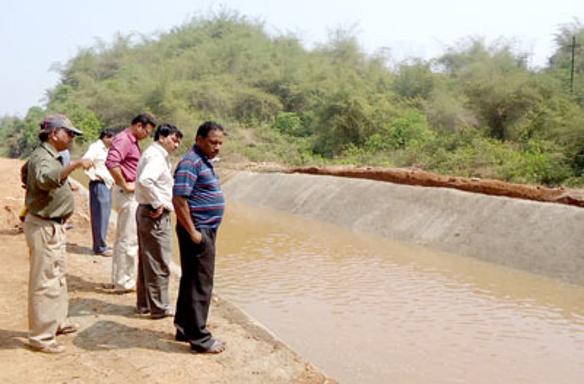 WRD Executive Engineer Shivanand Pattan and other officials inspect the repaired portion of the canal