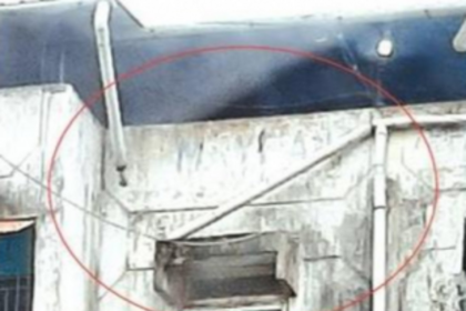 Water pipe hanging dangerously  from a building at Margao